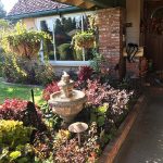 Bates front entrance with fountain and flowers Bates front entrance with fountain and flowers